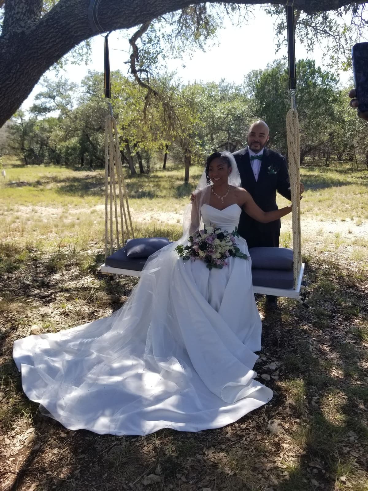 Scott and Kimberlyn seated together on the oak-tree swing at Prima Vista