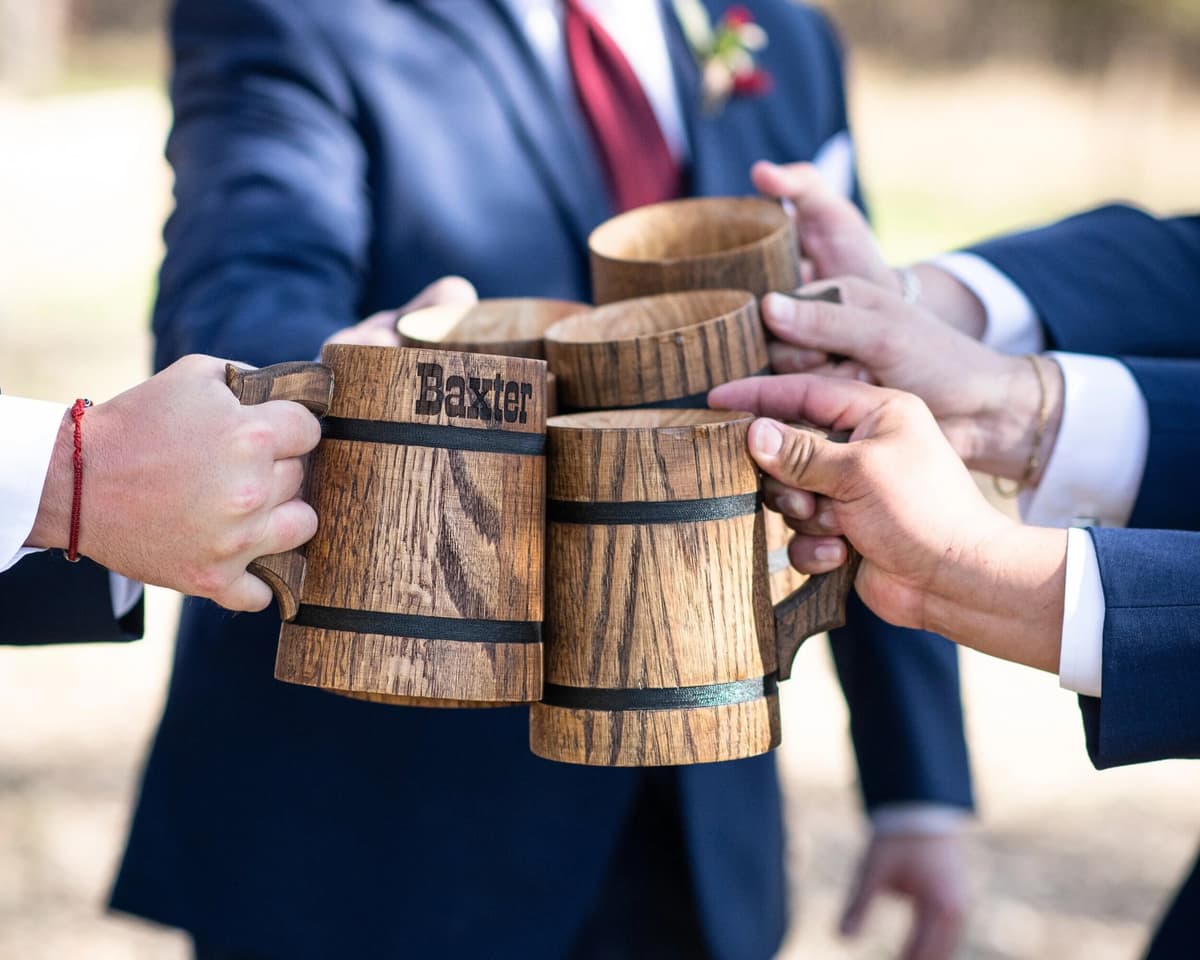 Guests celebrating with beer mugs at a Hill Country wedding