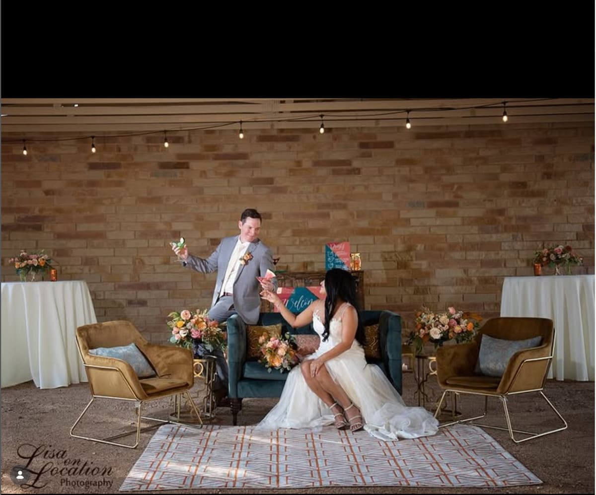 Newlyweds enjoying a cocktail lounge setup inside the covered pavilion