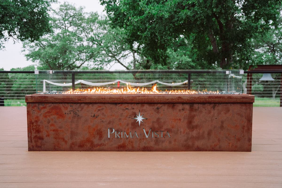 Prima Vista fire feature glowing on the outdoor deck