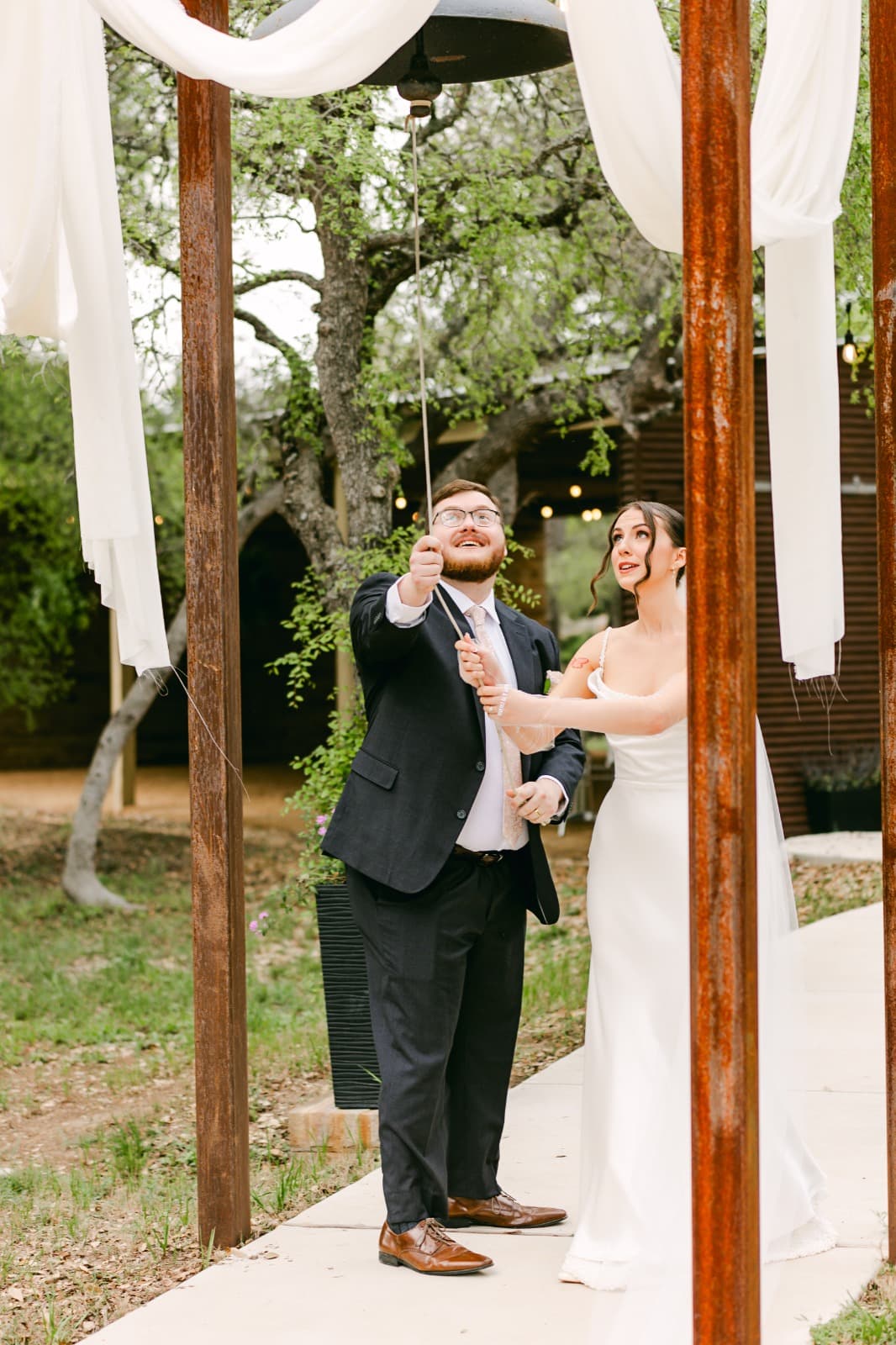 Newlyweds ringing the Victory Bell after their Prima Vista ceremony