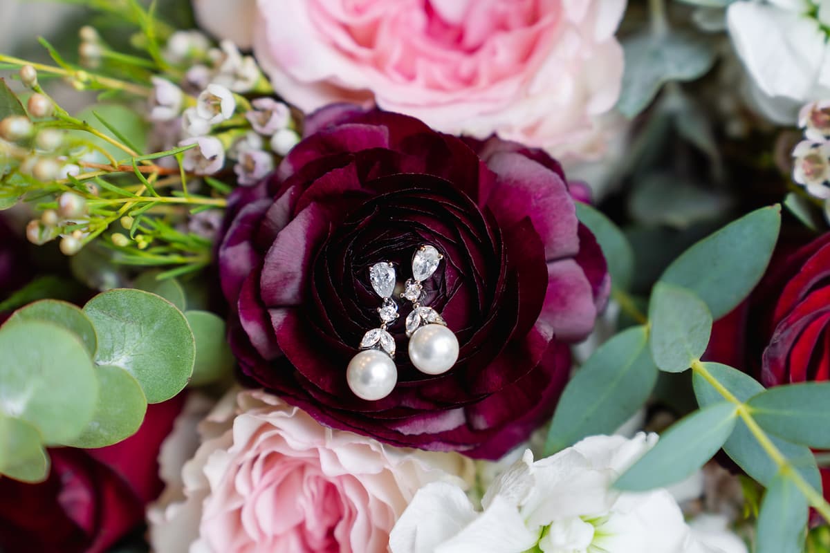 Burgundy, blush, and eucalyptus wedding flowers with Natasha's jewelry