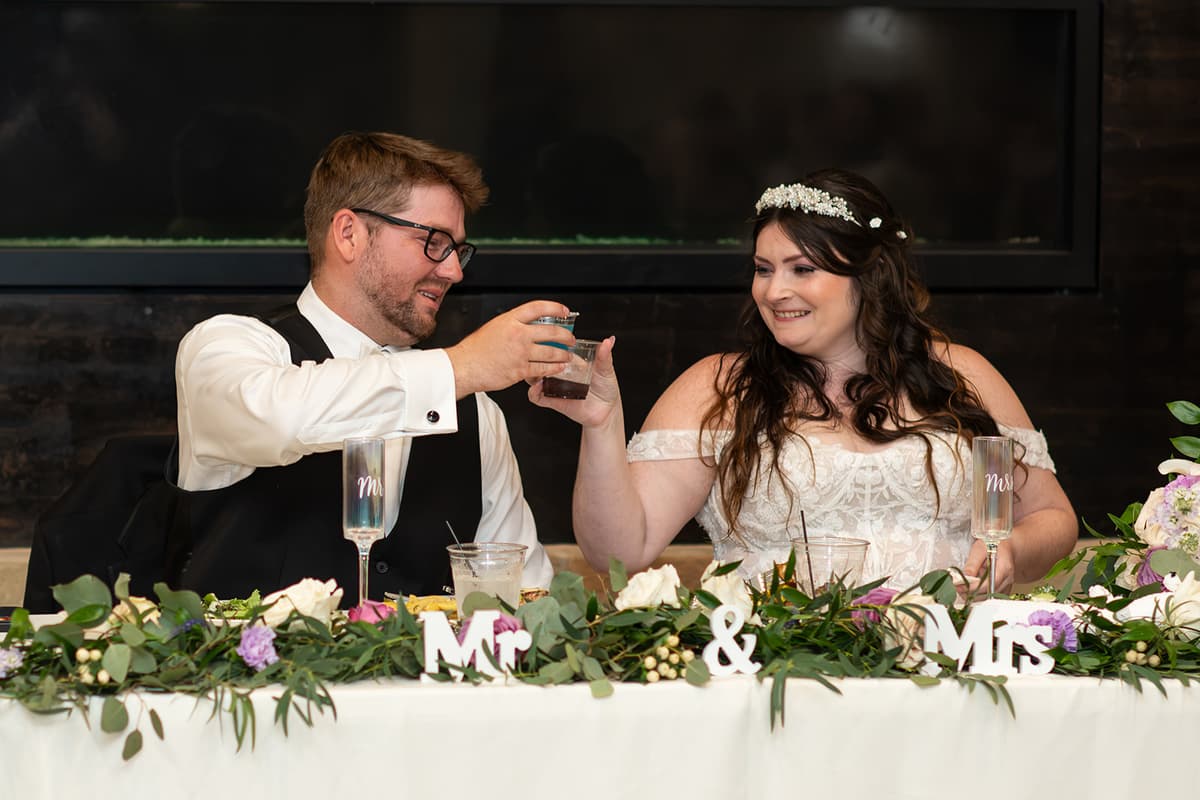 Nicole and Dylan share a toast at their sweetheart table