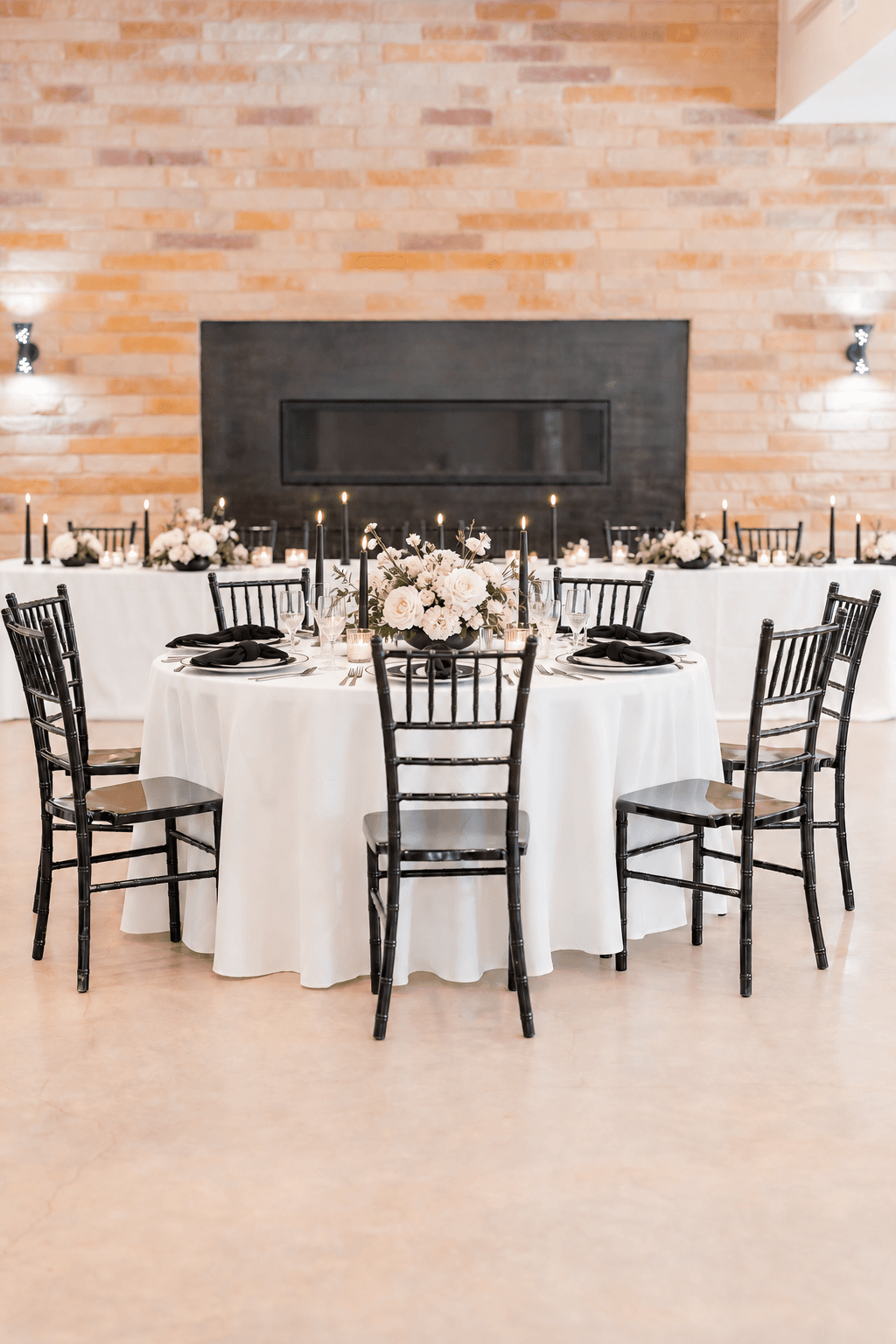 Black napkins and sculptural white florals on a modern table