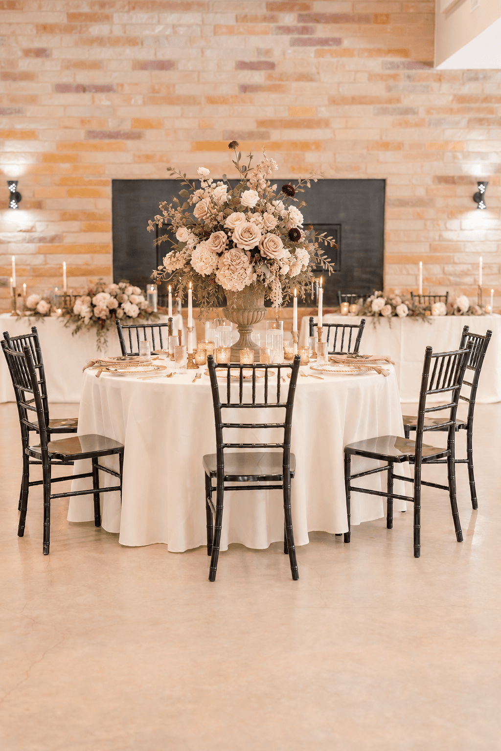 Fine-art flowers and antique brass on a reception table