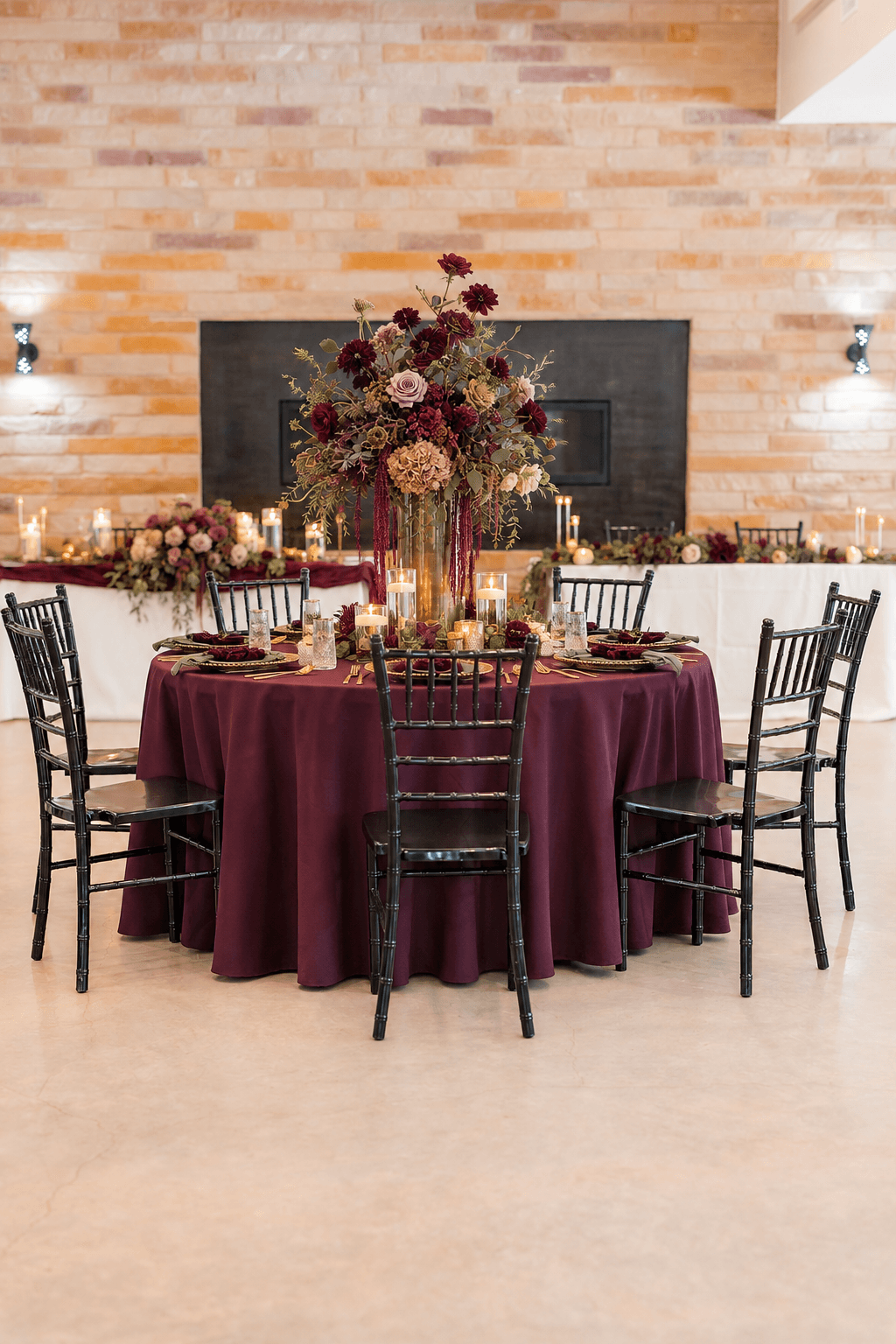 Plum textiles, botanical florals, and brass table details