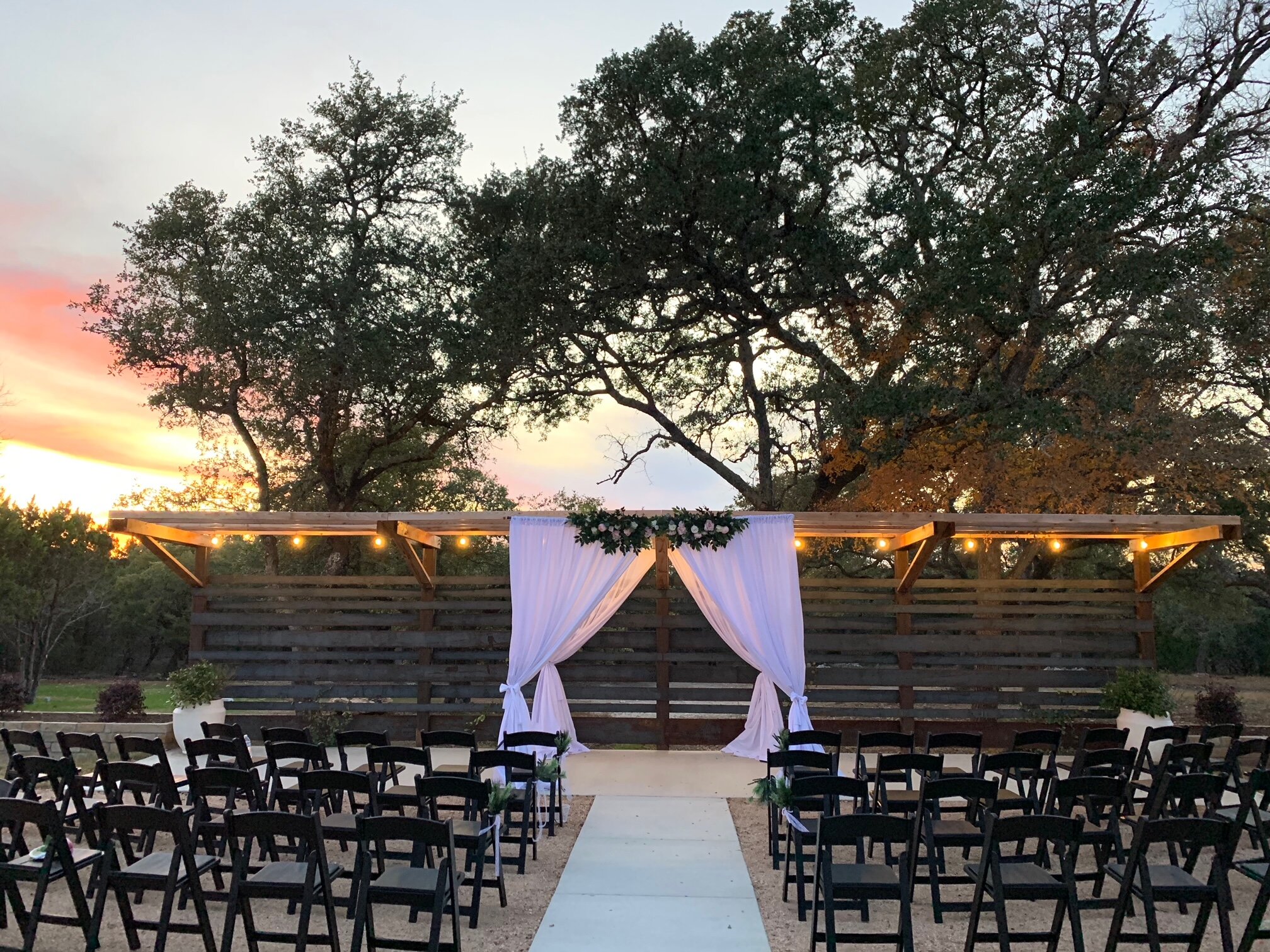 A breathtaking sunset wedding ceremony setup in the Texas Hill Country at Prima Vista
